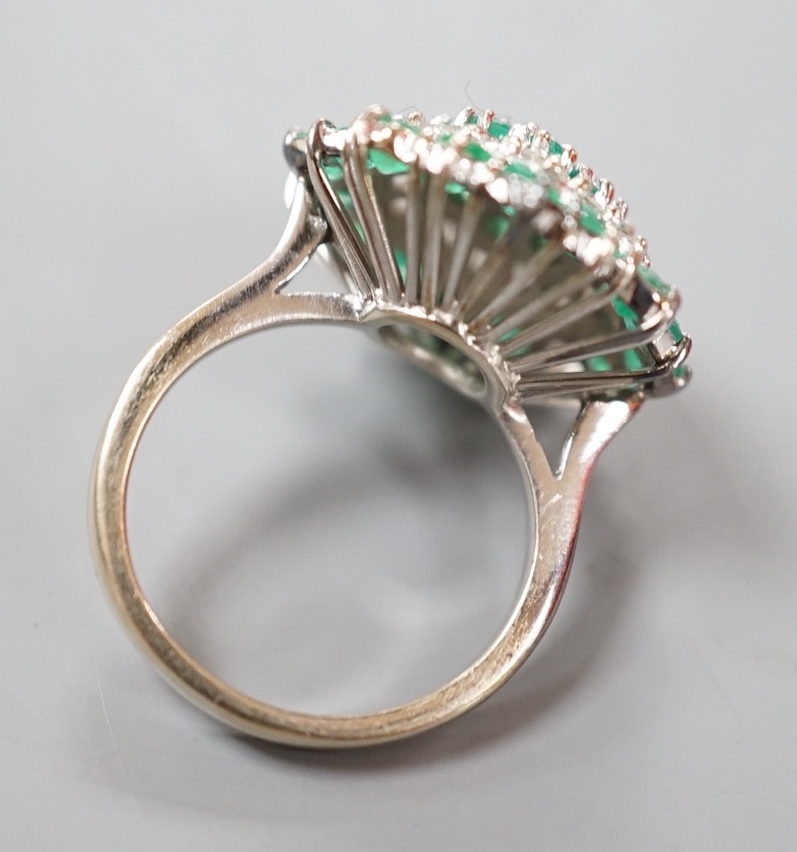 A modern 18ct white gold emerald and diamond cluster set dress ring, (emerald missing), size J, gross weight 6.9 grams.